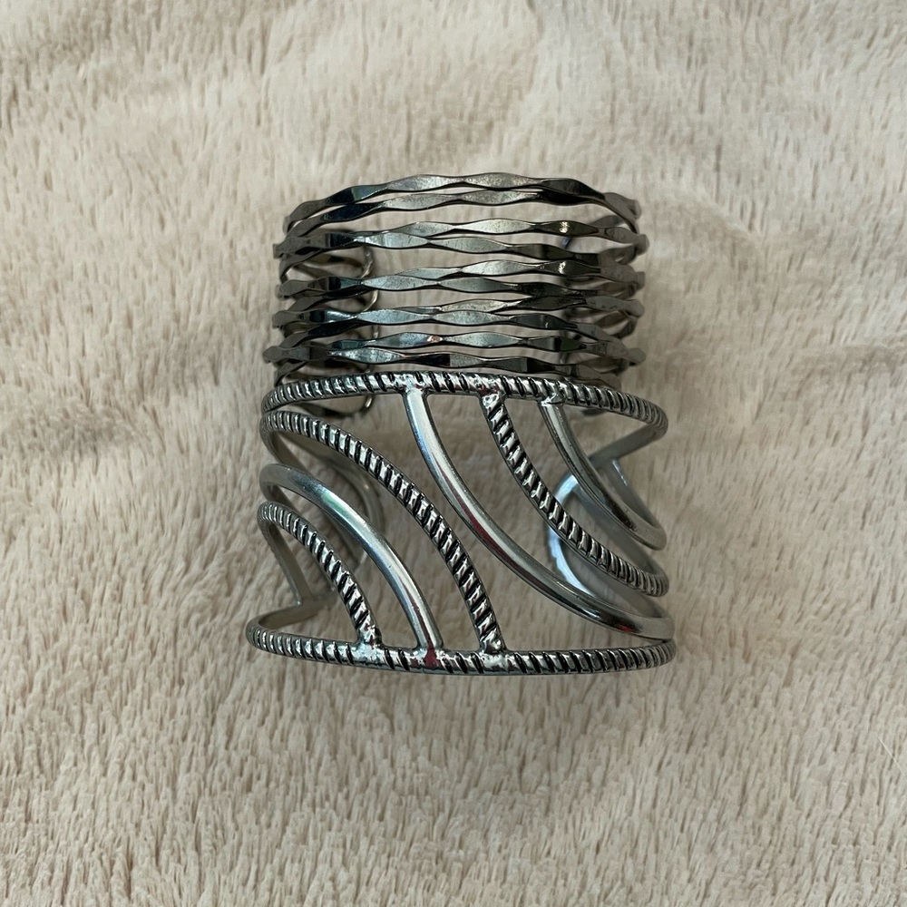 2 cuff bracelets silver colored and dark grey